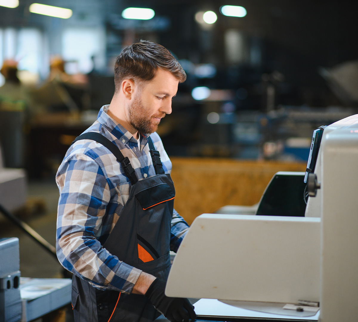 Industrial Print Operator working on print machinery